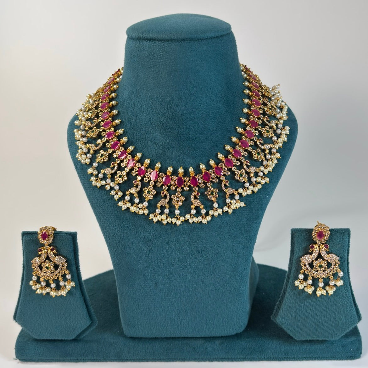 Gold plated necklace set with ruby color stones