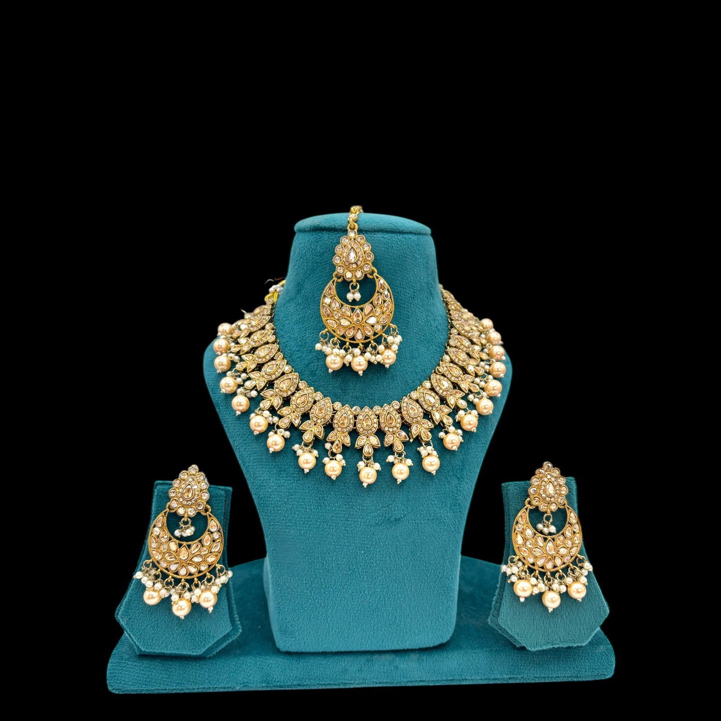 Party wear polki necklace set with chandbali and matha tikka.