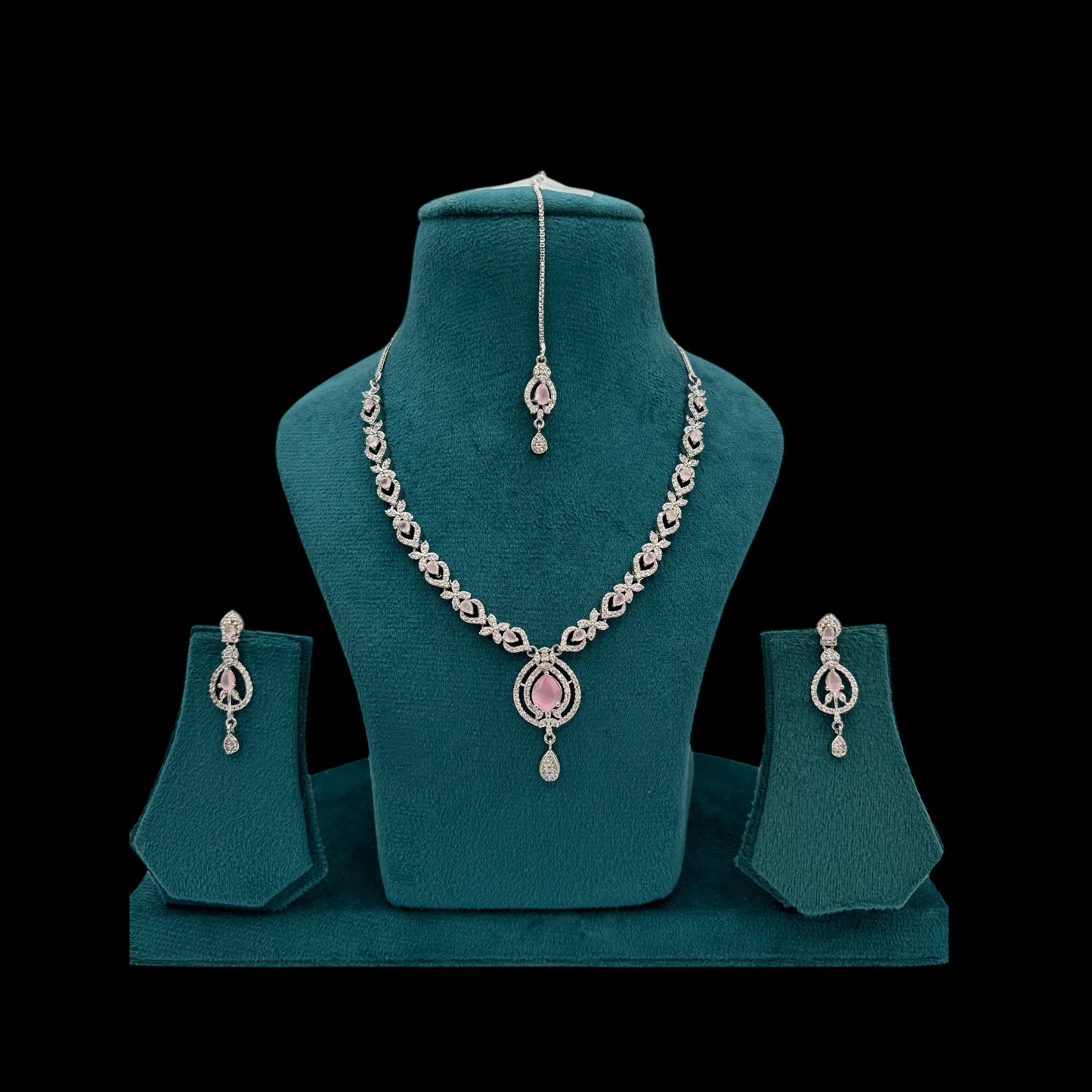 Rhodium plated pink American Diamond necklace set with matha tikka and earrings.