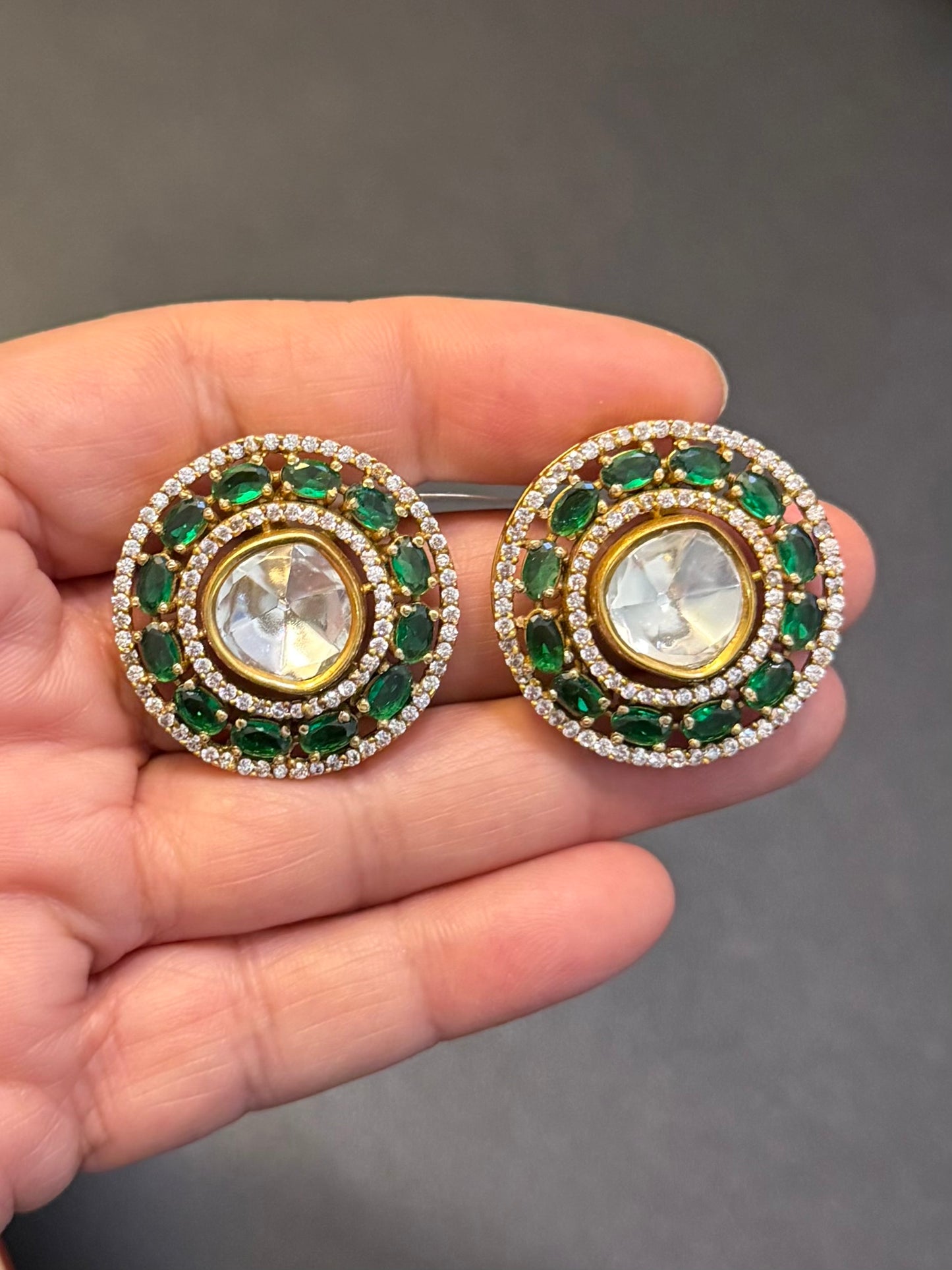Uncut kundan studs with emerald green stones