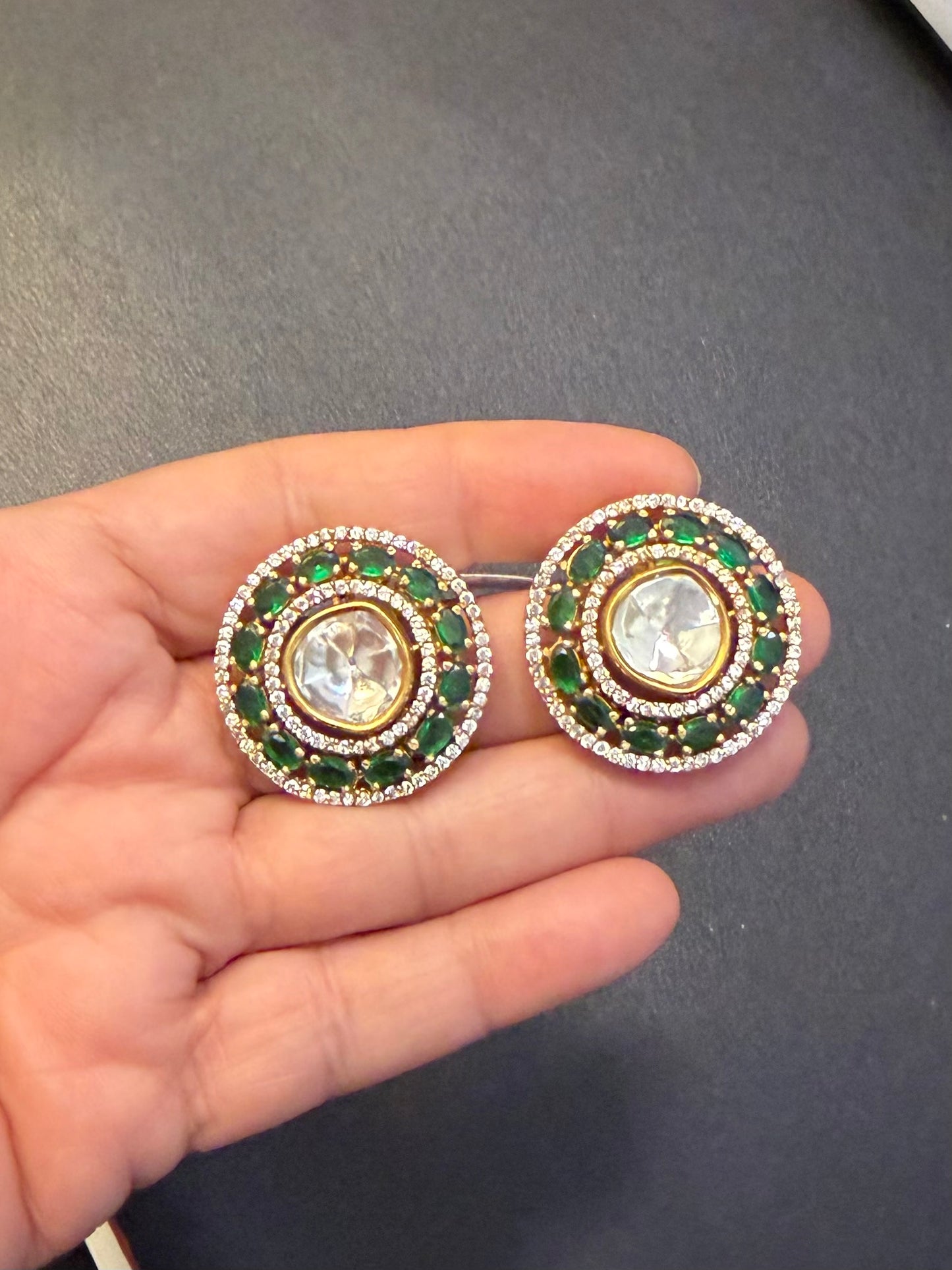 Uncut kundan studs with emerald green stones