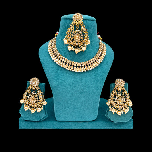 Simple and elegant polki necklace set with chandbali and matha tikka
