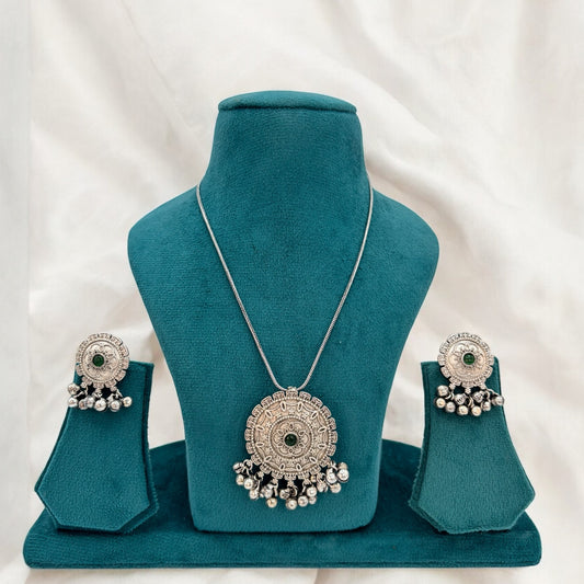 German silver chain pendant set with green stones.