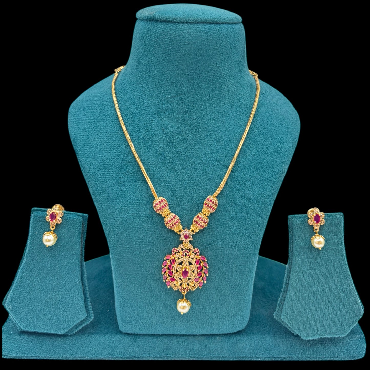 Gold plated American Diamond necklace set with ruby stones.
