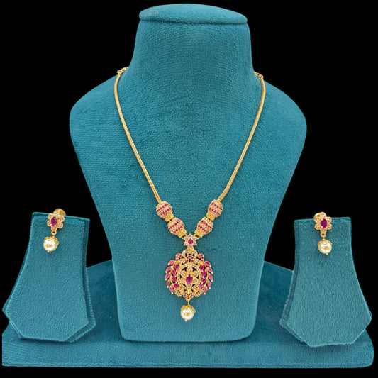 Gold plated American Diamond necklace set with ruby stones.